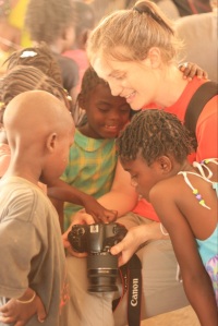 Kids in Haiti crowd around to see themselves in a camera’s tiny screen.