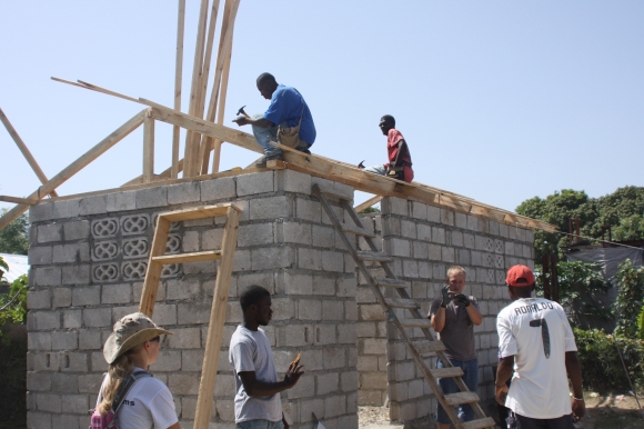 Preparing to put a roof on one of the new houses.