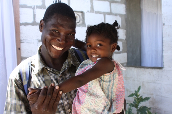 Thomas Ogens, who helped coordinate the building projects and deliver supplies, with Pastor Estephat's daughter.