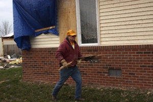 Disaster Relief volunteer Dave Weger from Sullivan, Ill., clears debris from a backyard in Washington.