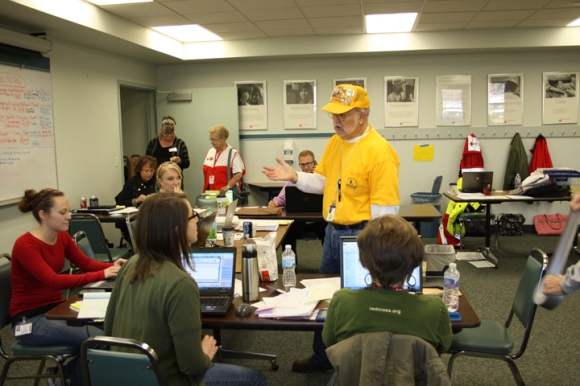Harold Booze, a Disaster Relief "blue cap" supervisor, visits the Red Cross command center to coordinate efforts between the two organizations.