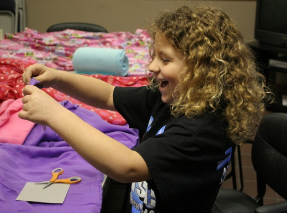 Jaide Soppe, 8, makes a fleece blanket for a Springfield shelter on Children's Ministry Day March 15.