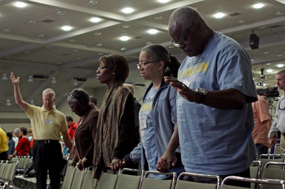 Christopher and Annette Robinson (right) pray alongside Linda Woods-Smith and Inez Parker at the Southern Baptist Convention in Baltimore. All four are Broadview Missionary Baptist Church.