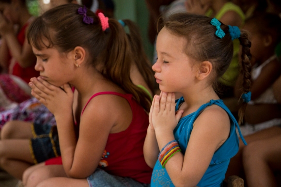 Cuban children learn to pray during a weekly meeting held in the home of two ladies with a passion to evangelize children. In 2010, the religious affiliation of Cuba was estimated by the Pew Forum to be 59.2 percent Christian (mostly Roman Catholic), 23.0 percent unaffiliated, 17.4 percent folk religion and the remaining 0.4 percent other religions. Wilson Hunter/IMB